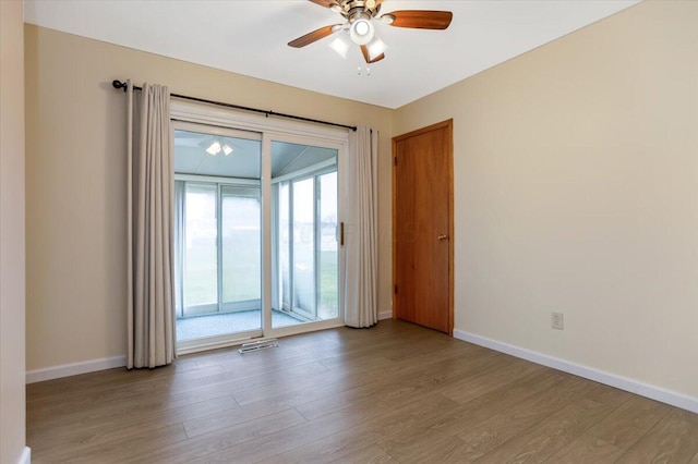 empty room featuring ceiling fan and light hardwood / wood-style flooring