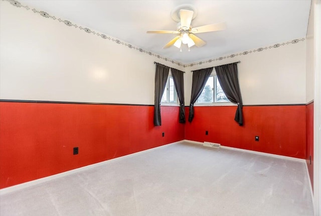 carpeted spare room with ceiling fan