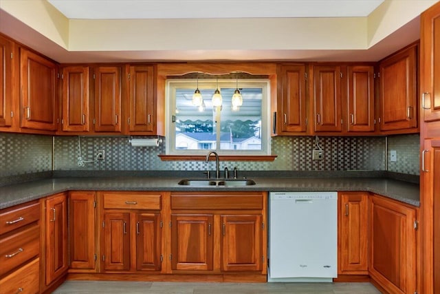 kitchen with tasteful backsplash, dishwasher, decorative light fixtures, and sink