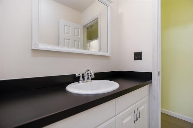 bathroom featuring vanity and hardwood / wood-style flooring