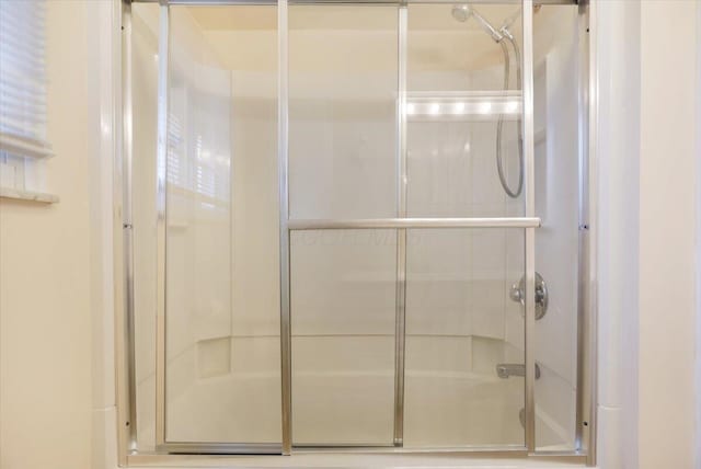 bathroom featuring a shower with door