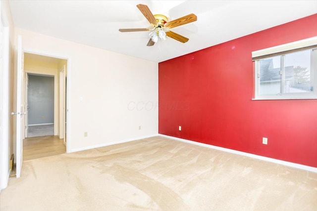 spare room featuring carpet flooring and ceiling fan