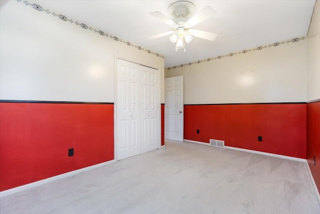 carpeted empty room with ceiling fan