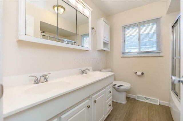 bathroom featuring hardwood / wood-style floors, vanity, and toilet