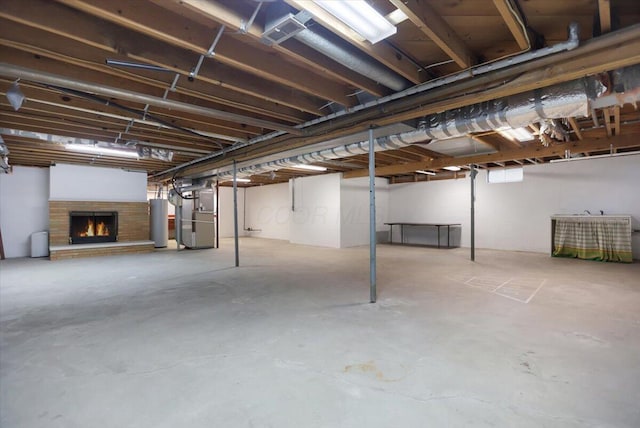 basement with heating unit, a fireplace, and gas water heater