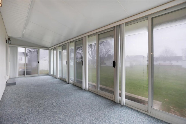 unfurnished sunroom with lofted ceiling