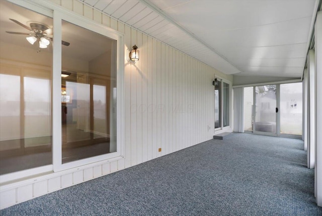 unfurnished sunroom with ceiling fan