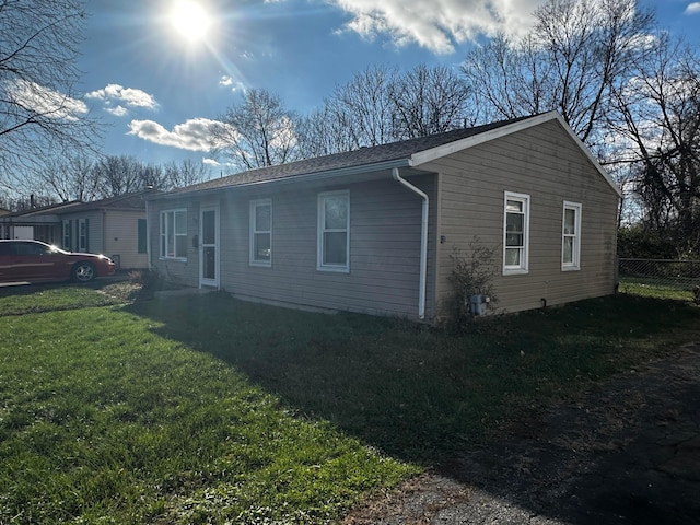 view of side of property with a lawn