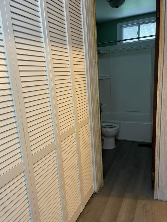 bathroom featuring hardwood / wood-style flooring and toilet