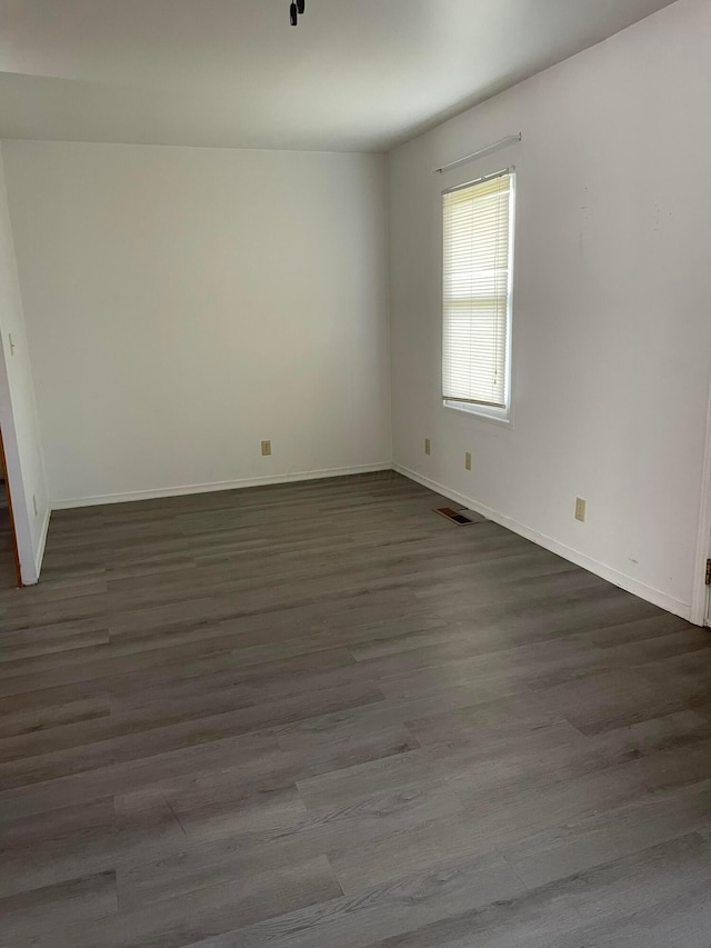 empty room with dark hardwood / wood-style floors