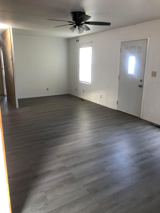 foyer with ceiling fan and dark hardwood / wood-style flooring