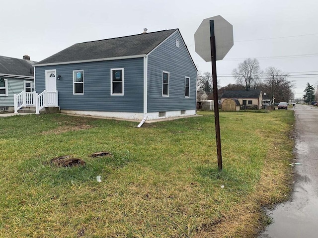 view of side of property with a lawn