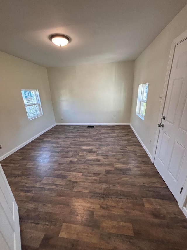 unfurnished room featuring dark hardwood / wood-style floors