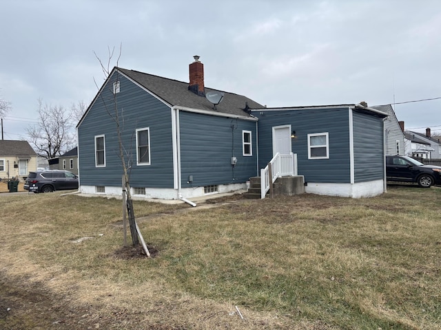 rear view of house with a lawn