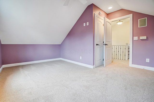 bonus room featuring ceiling fan, light colored carpet, and vaulted ceiling