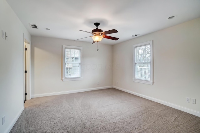 carpeted empty room featuring ceiling fan