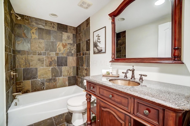 full bathroom featuring vanity, toilet, and tiled shower / bath