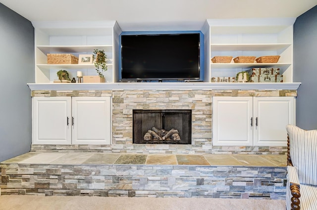 interior space featuring carpet and a stone fireplace