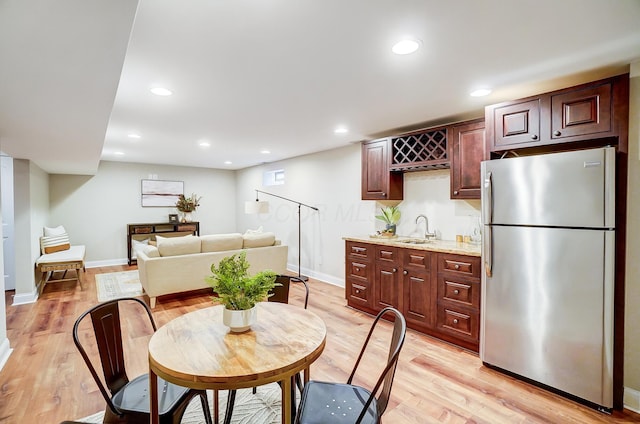 dining room featuring light wood-type flooring and sink