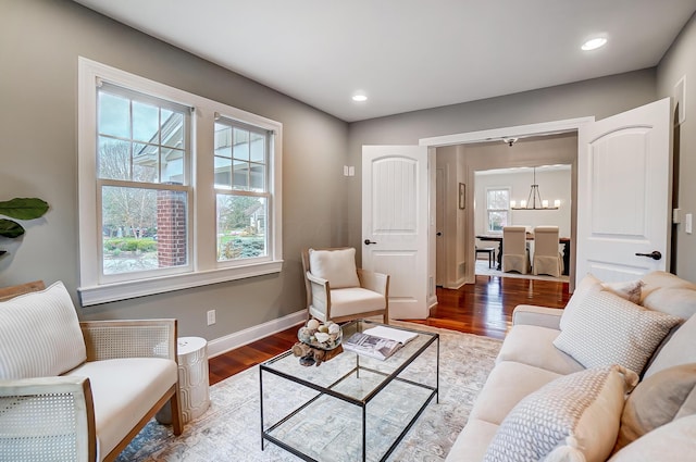 living room with a chandelier and wood-type flooring