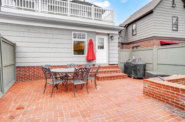 view of patio / terrace featuring a grill and a balcony