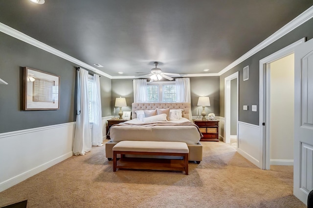 carpeted bedroom with ceiling fan and ornamental molding