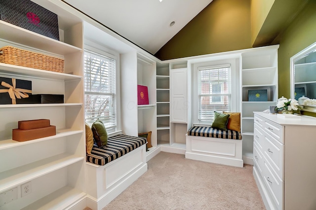 walk in closet featuring light colored carpet and lofted ceiling