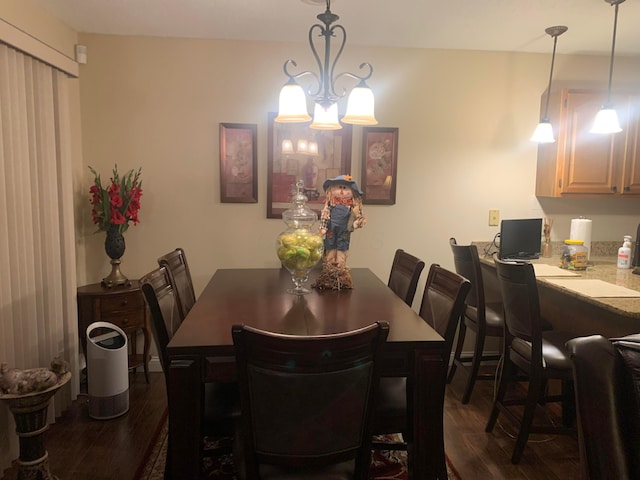 dining room with dark wood-type flooring and a chandelier