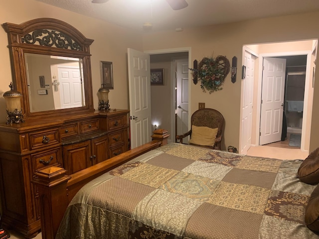 bedroom featuring ensuite bath and ceiling fan