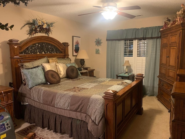 bedroom with a textured ceiling, ceiling fan, and light carpet