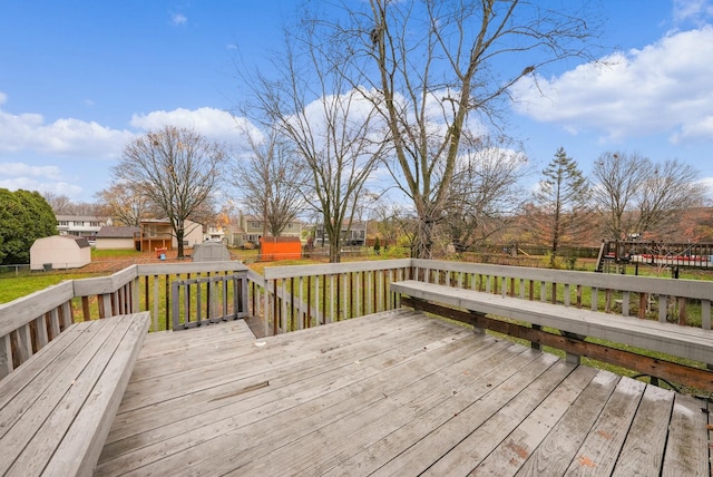 wooden deck featuring a storage unit