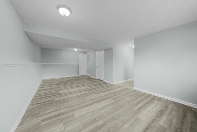 interior space with light wood-type flooring and a textured ceiling