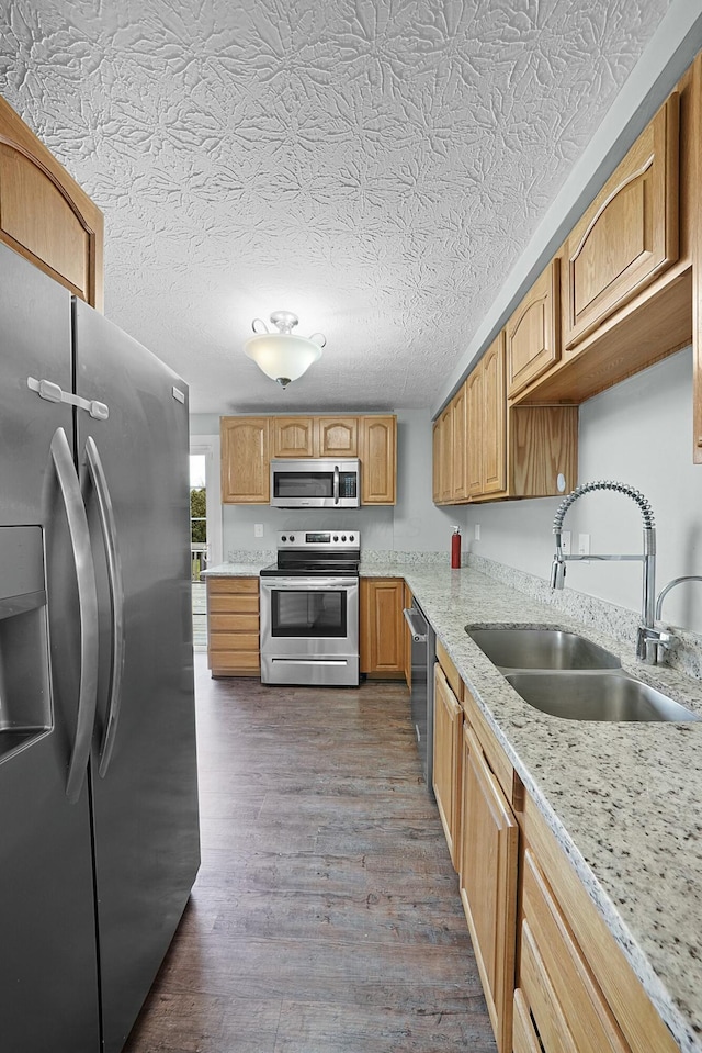 kitchen with sink, dark wood-type flooring, a textured ceiling, and appliances with stainless steel finishes