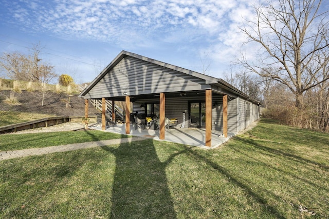 back of property featuring a yard and a patio