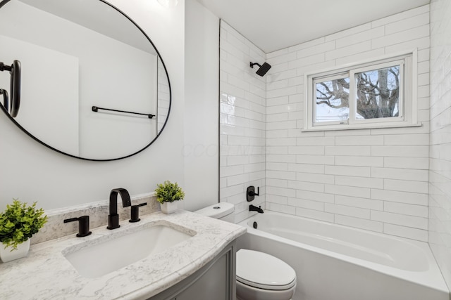 full bathroom with vanity, tiled shower / bath combo, and toilet