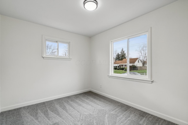 carpeted empty room with plenty of natural light