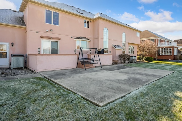 rear view of house with a patio area and a yard