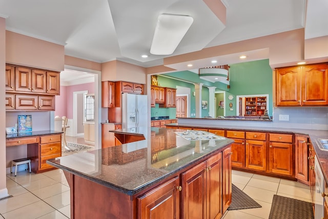 kitchen featuring white appliances, crown molding, decorative backsplash, light tile patterned floors, and a kitchen island