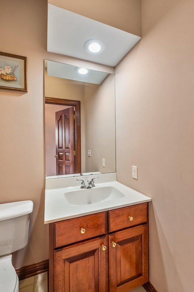 bathroom with tile patterned floors, vanity, and toilet