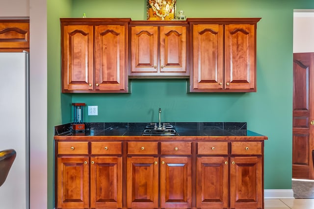 kitchen with refrigerator and light tile patterned floors