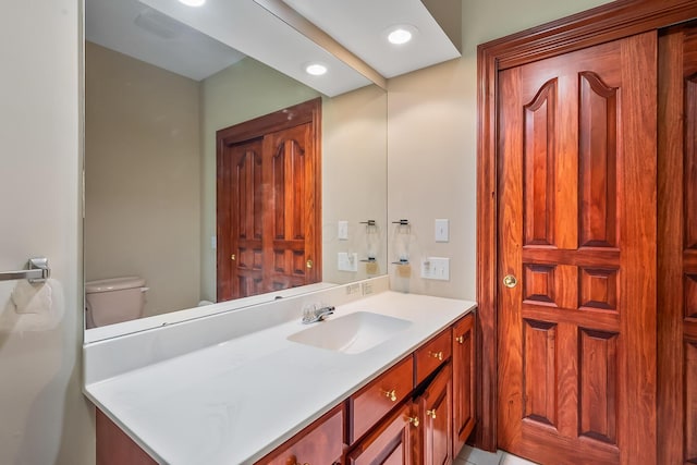 bathroom with vanity and toilet