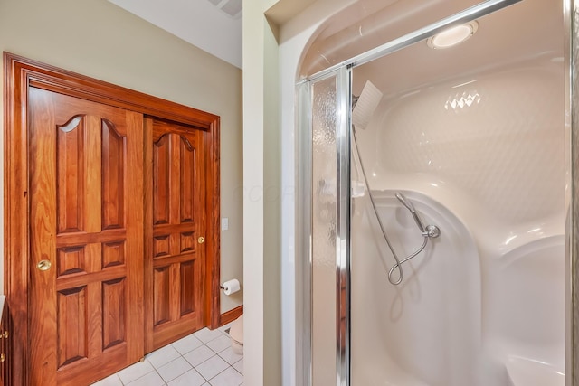 bathroom with tile patterned floors and walk in shower