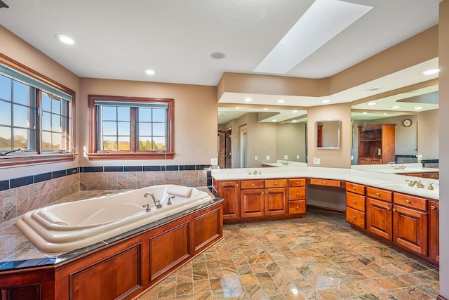 bathroom featuring vanity and a tub