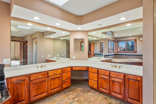 bathroom featuring vanity and a skylight