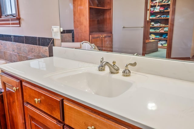 bathroom featuring tasteful backsplash and vanity