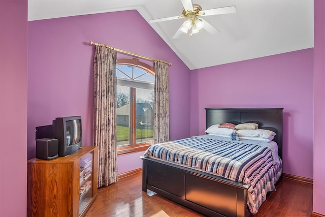 bedroom featuring ceiling fan, hardwood / wood-style floors, and lofted ceiling