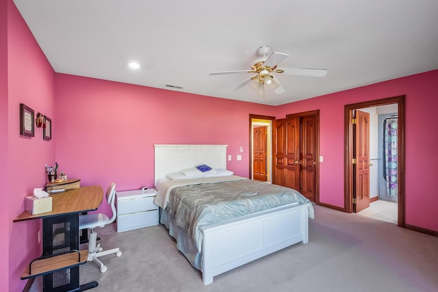 bedroom with ceiling fan, light carpet, and a closet