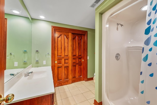 bathroom with tile patterned flooring, vanity, toilet, and a shower with shower curtain