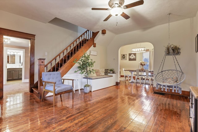 interior space featuring ceiling fan, wood-type flooring, and lofted ceiling