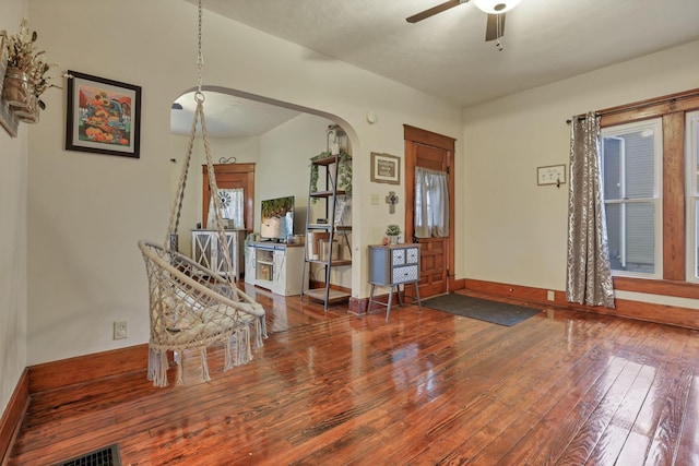 foyer entrance featuring wood-type flooring, vaulted ceiling, and ceiling fan